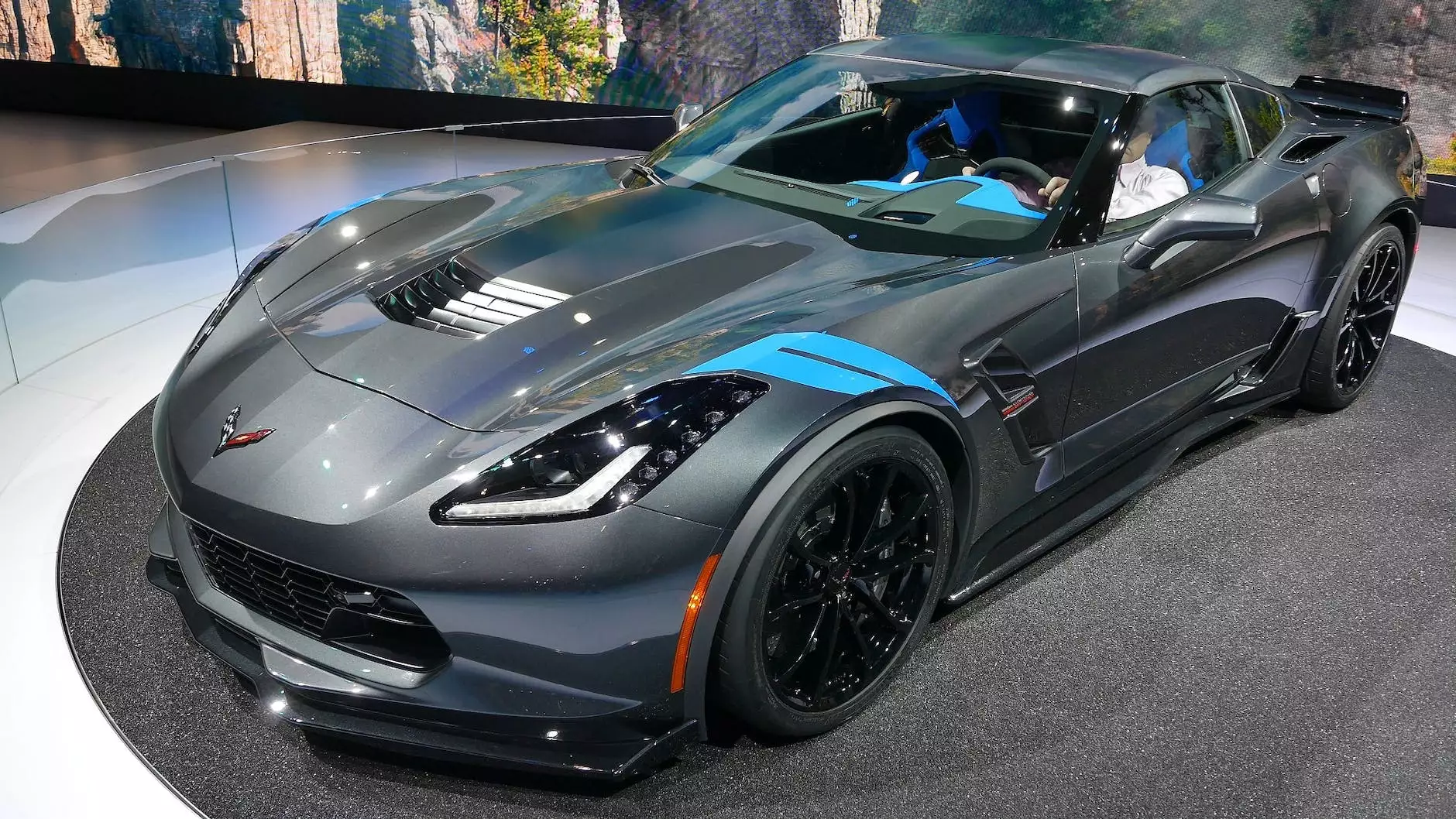 Reflections across the hood and fender of a graphite sports car